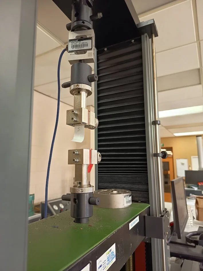 LASRA Instron mechanical testing setup holding a material specimen.